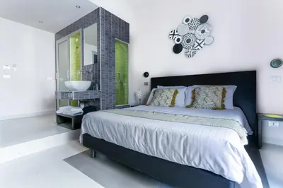 a bedroom with a large bed and a sink at Moai Home in Rome