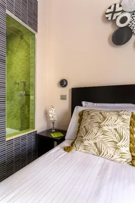 a bedroom with a large bed and a shower at Moai Home in Rome