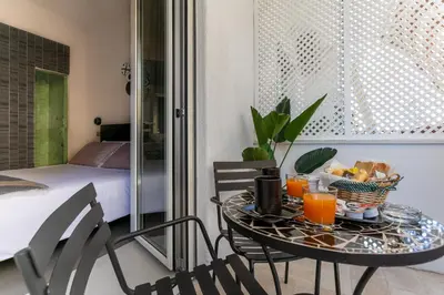 a table with a tray of food and orange juice at Moai Home in Rome