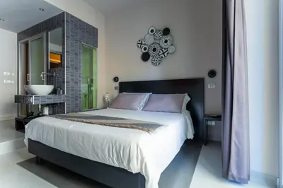 a bedroom with a large bed and a clock on the wall at Moai Home in Rome
