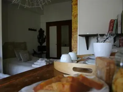 a room with a bed and a table with a plate of food at Le Fate Apartments in Rome