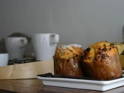 two muffins on a plate on a table at Le Fate Apartments in Rome