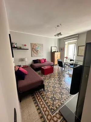 a living room with a couch and a table at Vatican Color House in Rome