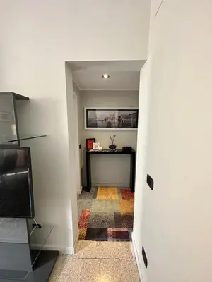 a hallway with a desk in a room at Vatican Color House in Rome