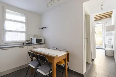 a kitchen with a table and chairs in a room at Emma's Apartment Borgo, Vatican City in Rome