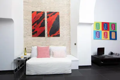 a bedroom with a white bed with two pillows at L’ARTSHOP in Rome