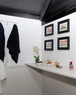 a white bathroom with a counter and a shelf at L’ARTSHOP in Rome