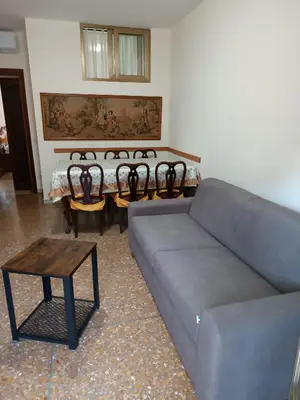 a living room with a couch and chairs and a table at Hortis Apartment, 5 persone, 2 camere, balcone, Metro C per il Colosseo a 10 minuti e tram per Termini a 2 minuti in Rome