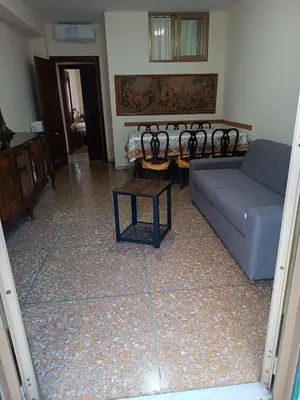 a living room with a couch and a table at Hortis Apartment, 5 persone, 2 camere, balcone, Metro C per il Colosseo a 10 minuti e tram per Termini a 2 minuti in Rome