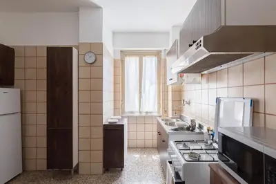 a kitchen with a sink and a stove top oven at Hortis Apartment, 5 persone, 2 camere, balcone, Metro C per il Colosseo a 10 minuti e tram per Termini a 2 minuti in Rome