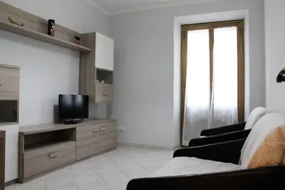 a living room with a couch and a television at Rhome202 in Rome