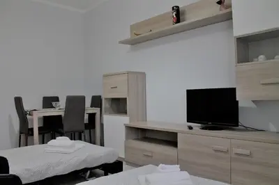 a room with a tv and a table with chairs at Rhome202 in Rome