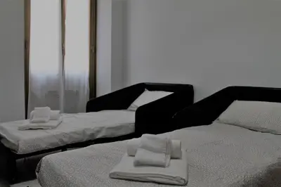 two beds in a room with towels on them at Rhome202 in Rome