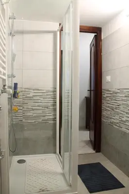 a shower with a glass door in a bathroom at Rhome202 in Rome