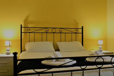 a bed with a black frame and two white pillows at Rhome202 in Rome