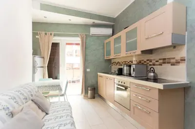 a kitchen with a couch and a table in a room at San Pietro Home in Rome