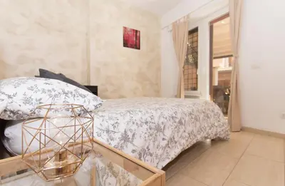 a bedroom with a bed and a glass table at San Pietro Home in Rome