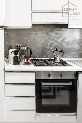 a kitchen with a stove top oven in a kitchen at Come a Casa in Rome