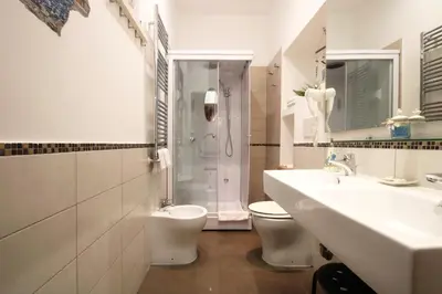 a bathroom with a sink and a toilet and a shower at Vatication B&B in Rome
