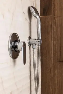 a shower head with a hose attached to a wall at Classic Flat Monti in Rome