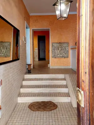 a hallway with a tile floor and a hallway with a door at Classic Flat Monti in Rome