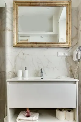 a bathroom with a white sink and a mirror at Classic Flat Monti in Rome