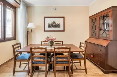 a dining room with a wooden table and chairs at ROMAN DREAM I in Rome
