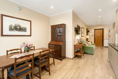 a dining room and living room with a table and chairs at ROMAN DREAM I in Rome