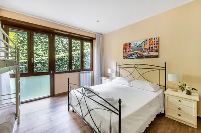 a bedroom with a bed and a large window at ROMAN DREAM I in Rome