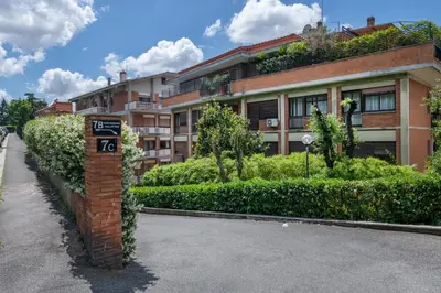 a brick pole with a sign in front of a building at ROMAN DREAM I in Rome
