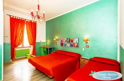 a bedroom with a red bed and green walls at Dream Station 2 in Rome