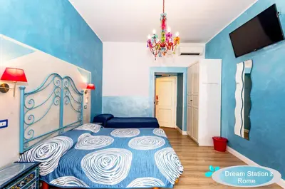 a bedroom with a bed and a chandelier at Dream Station 2 in Rome