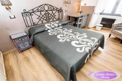 a bedroom with a black and white bed and a desk at Dream Station 2 in Rome