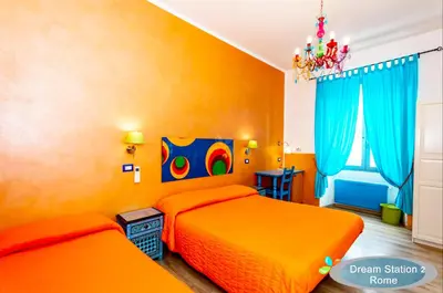 a bedroom with two orange beds and a chandelier at Dream Station 2 in Rome
