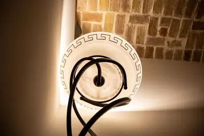 a lamp with a cord plugged into a wall at Dillo Suites in Rome