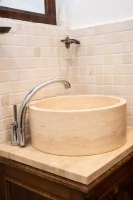 a wooden sink with a faucet on a counter at Dillo Suites in Rome