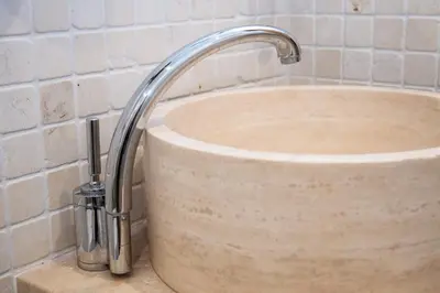 a sink with a faucet in a bathroom at Dillo Suites in Rome