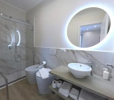 a bathroom with a sink and a shower and a mirror at B&B Aurelia Garden Rooms in Rome
