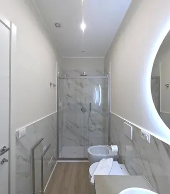 a bathroom with a shower and a toilet and a sink at B&B Aurelia Garden Rooms in Rome