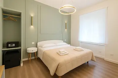 a bedroom with a bed with two towels on it at B&B Aurelia Garden Rooms in Rome