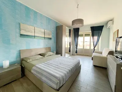 a bedroom with a bed and a couch in it at Bibbi's House San Lorenzo in Rome