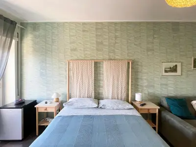 a bedroom with a large bed and a couch at Bibbi's House San Lorenzo in Rome