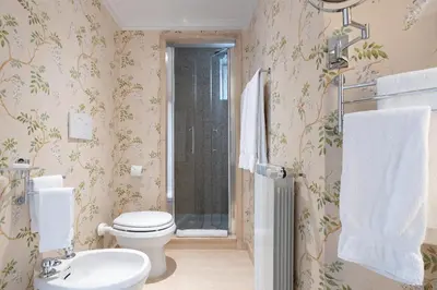a bathroom with a toilet and a sink and a shower at Colonna Traiana - The View Boutique Luxury Home in the center of ancient Rome in Rome