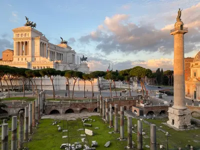 a view of a square with a column and a building at Colonna Traiana - The View Boutique Luxury Home in the center of ancient Rome in Rome