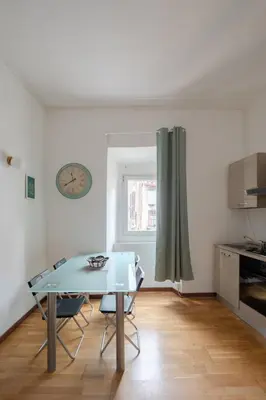 a kitchen with a table and chairs in a room at Trastevere Heart Home in Rome
