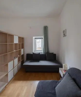 a living room with a couch and a window at Trastevere Heart Home in Rome