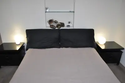 two dogs sitting on top of a bed with two lamps at Alloggio Turistico Roberta San Pietro in Rome