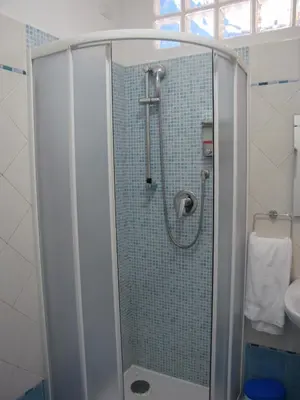a shower with a glass door in a bathroom at Aracoeli in Rome