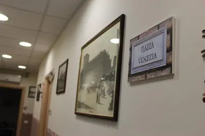 a picture hanging on a wall in a hallway at Aracoeli in Rome