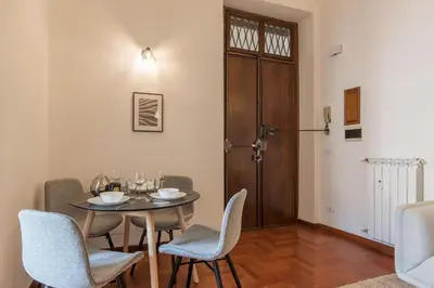a dining room with a table and chairs at Lively Roma Trastevere renovated apartment - FromHometoRome in Rome